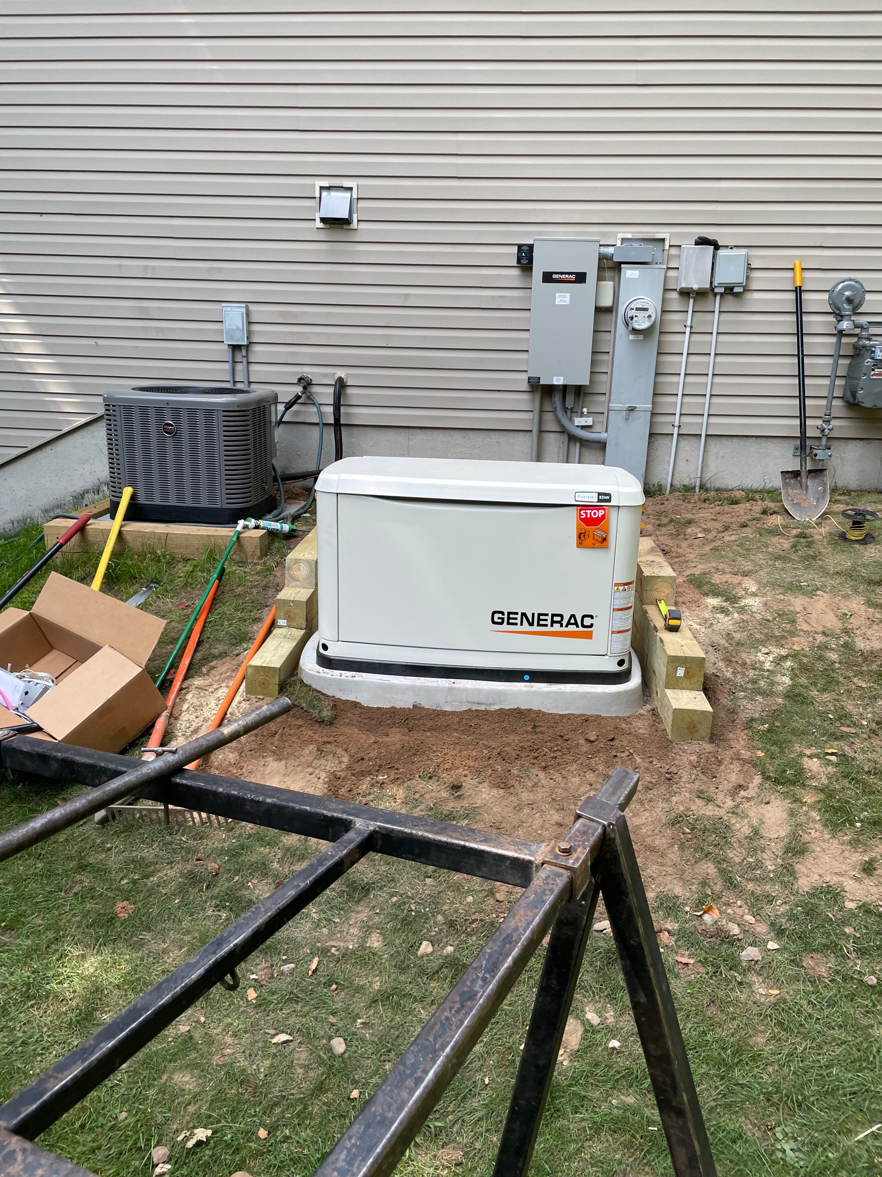 Generac generator and transfer switch mid-installation with tools on site