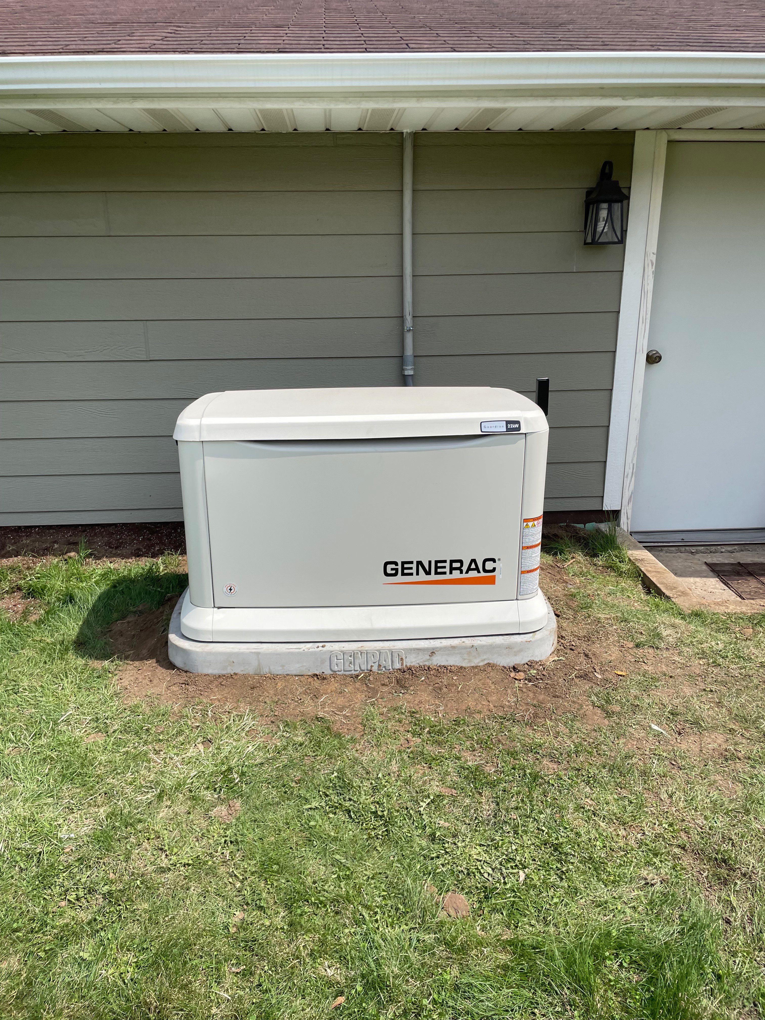 Finished Generac Guardian home standby generator on a composite pad